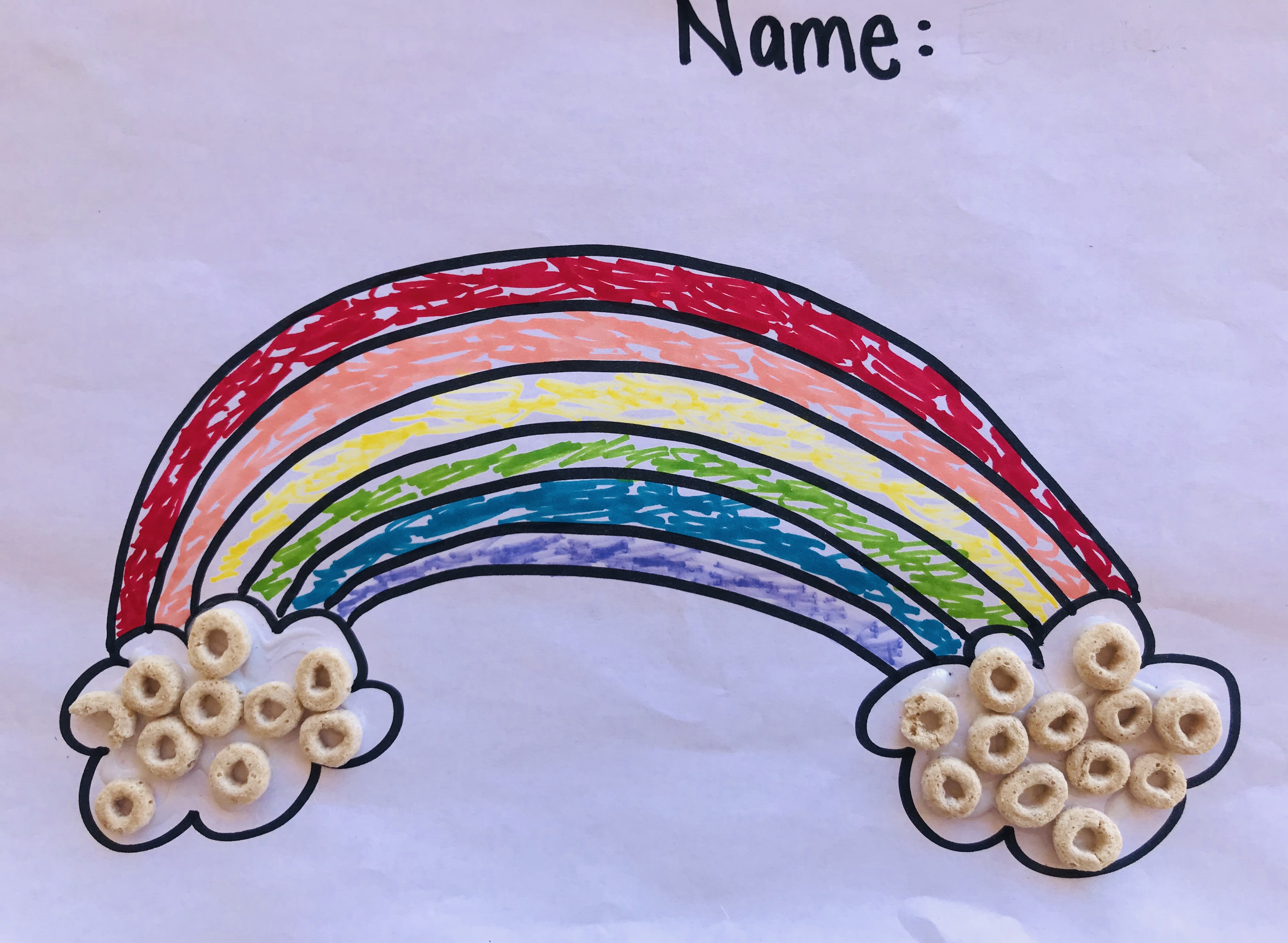 Colored rainbow printout with Cheerio clouds