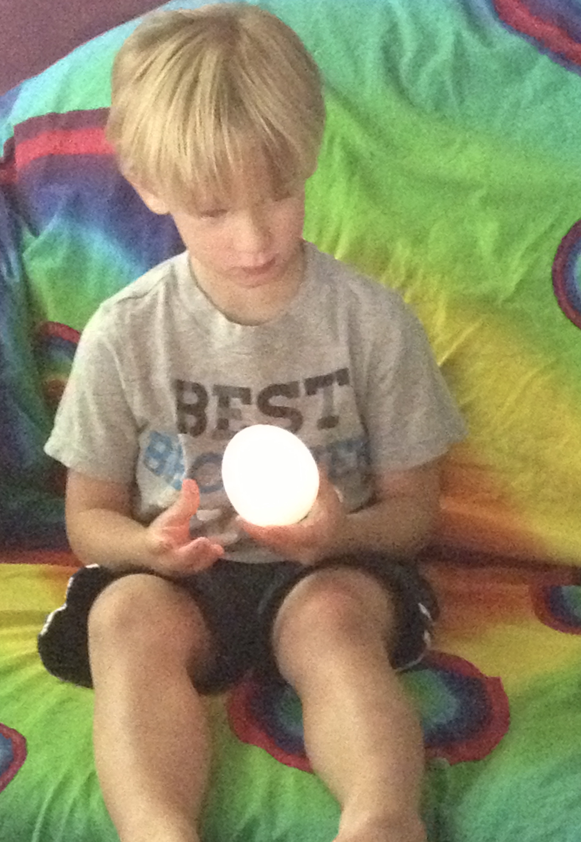 Little boy looking at glowing magic egg
