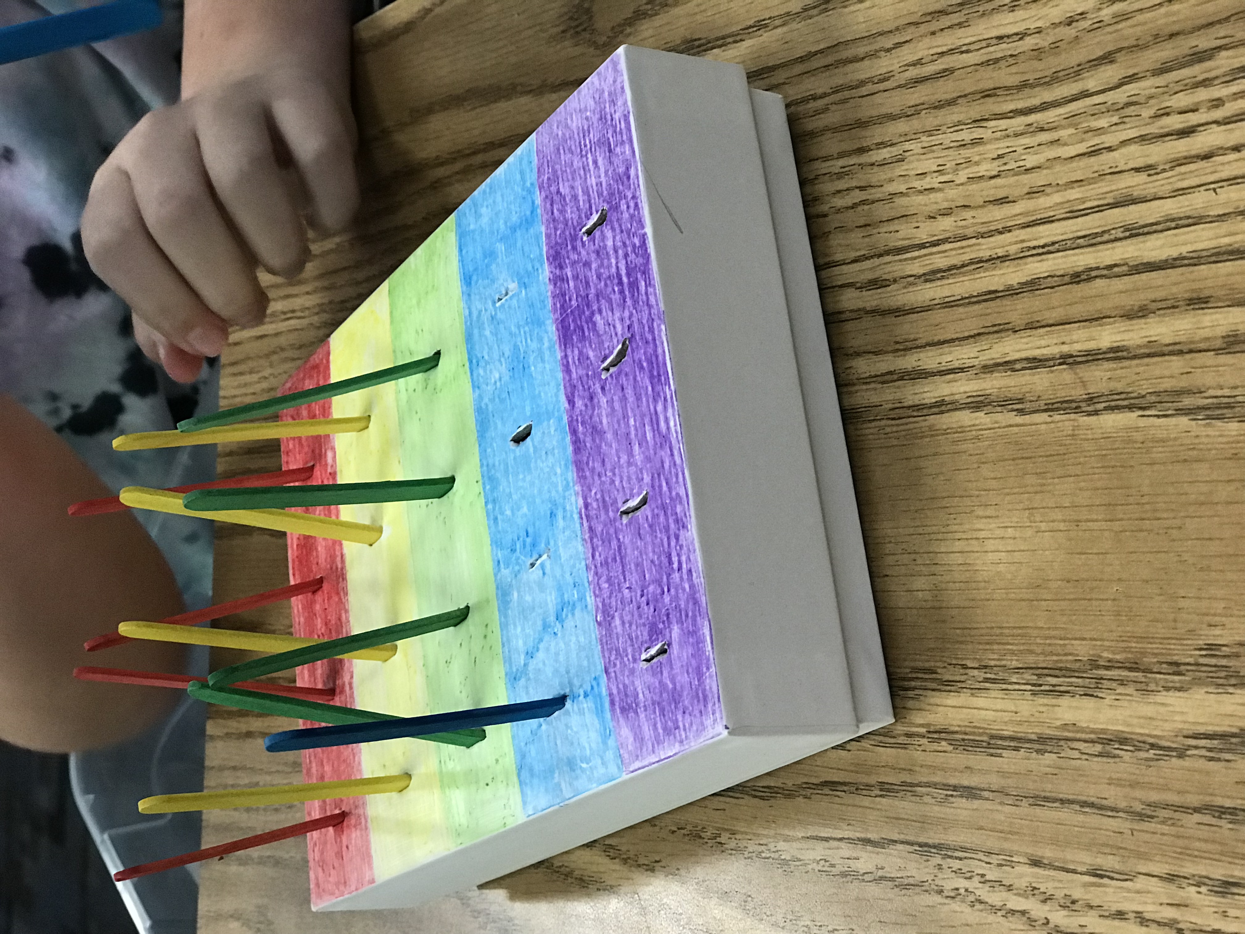 Colored paper box with corresponding color popsicle sticks