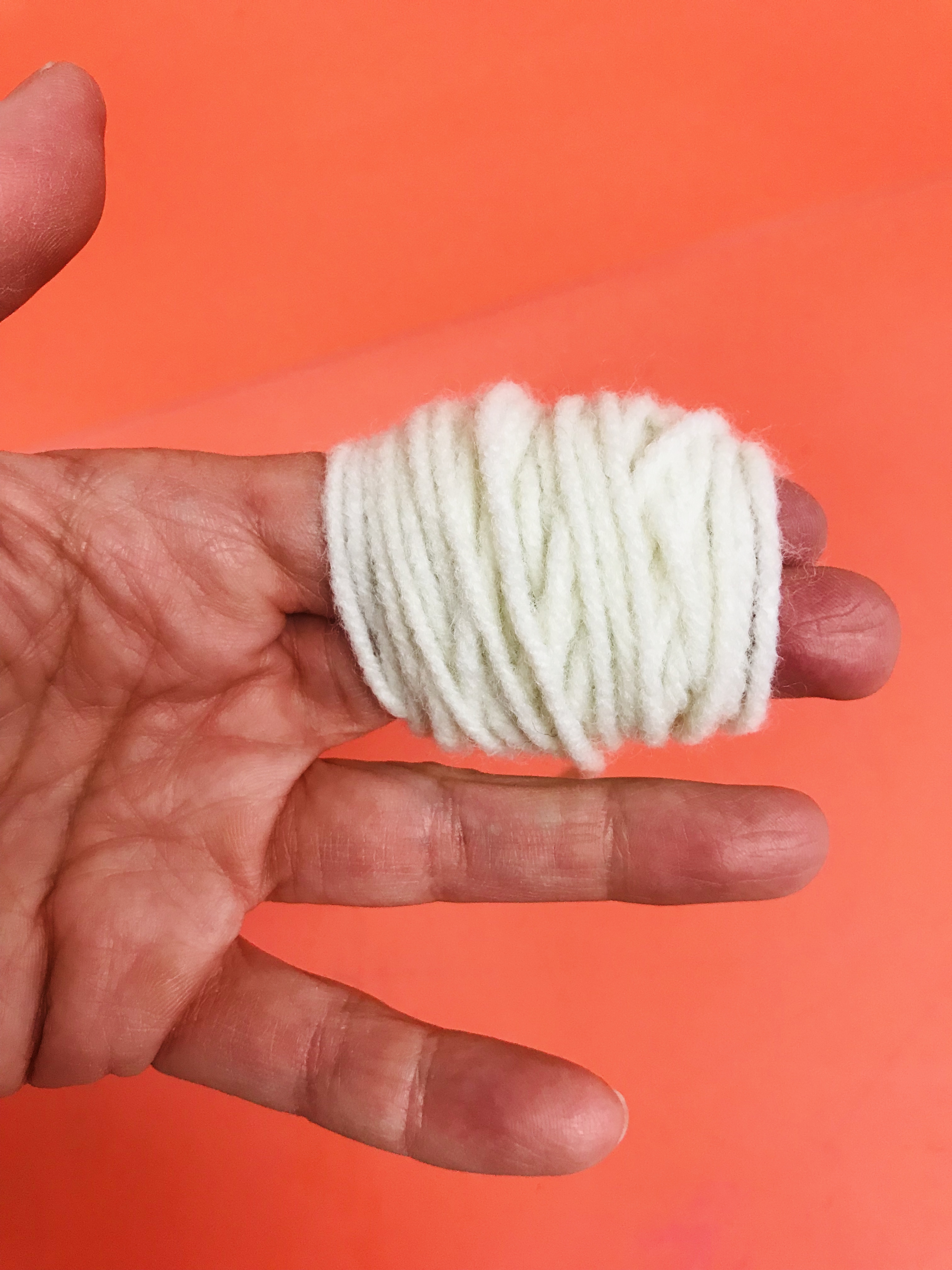 Fingers wrapped in yarn