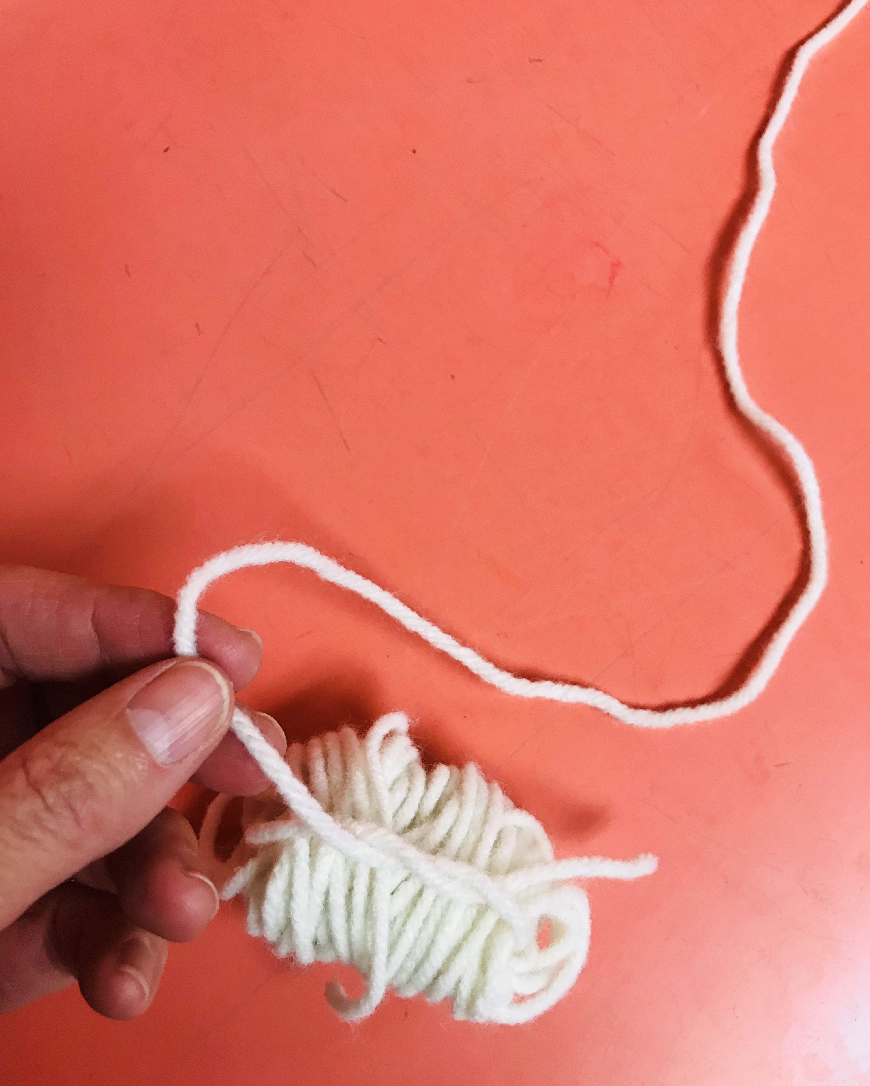 Tying yarn ball with string